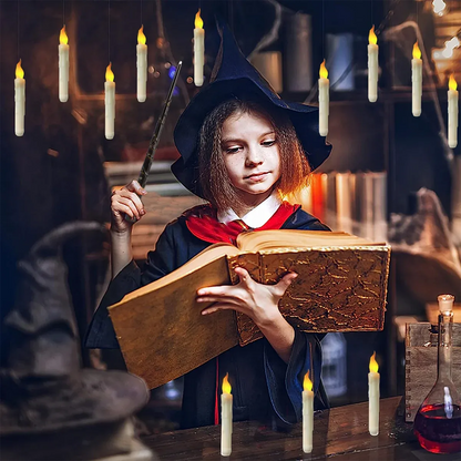 Child in wizard costume holding a book and wand in a candlelit room